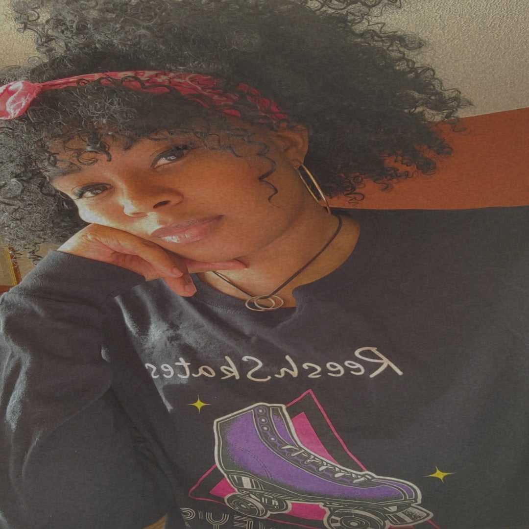 Person wearing a black sweatshirt with graphic design and text