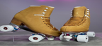Tan roller skates with white wheels on a gray surface with a neon sign in the background.